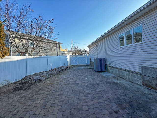 view of patio / terrace featuring central AC unit, a gate, and fence