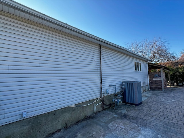 view of property exterior featuring a patio and central AC