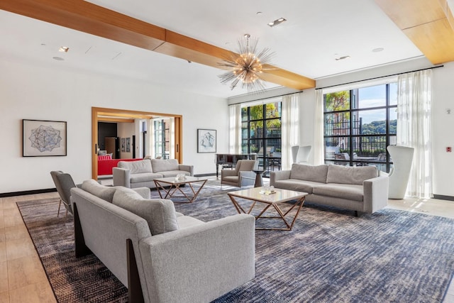 living room featuring baseboards and a chandelier