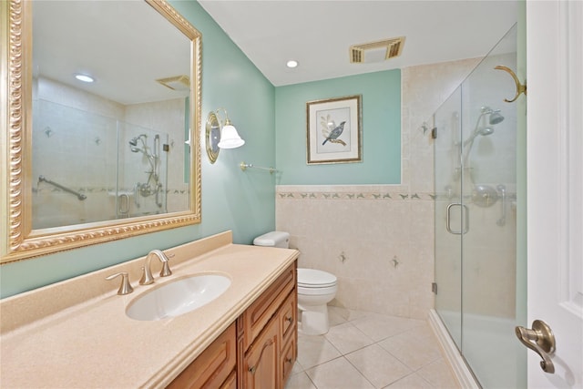 full bath with tile patterned flooring, tile walls, visible vents, and a stall shower