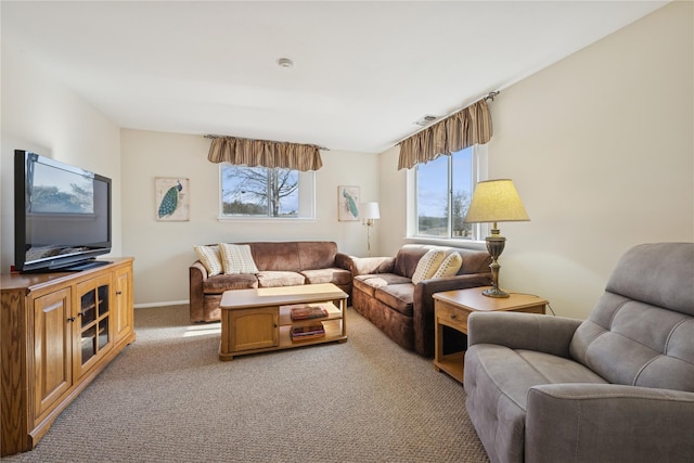 living room with baseboards, light carpet, and visible vents