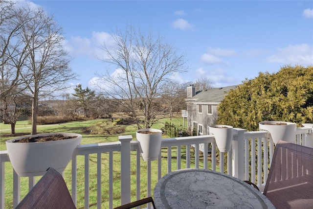 deck featuring a lawn and outdoor dining area