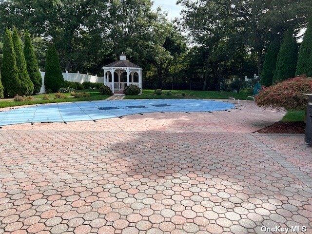 view of swimming pool with a gazebo, a fenced in pool, and a patio