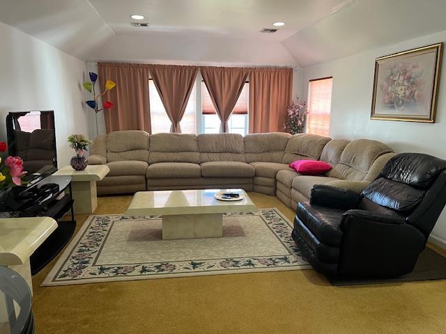 living room featuring recessed lighting, visible vents, and lofted ceiling