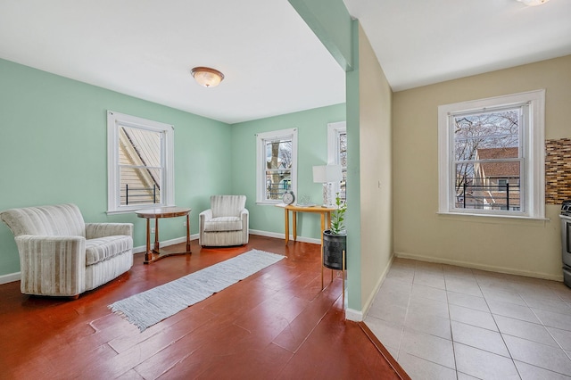 sitting room featuring baseboards and wood finished floors