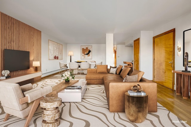 living area featuring a baseboard radiator and wood finished floors