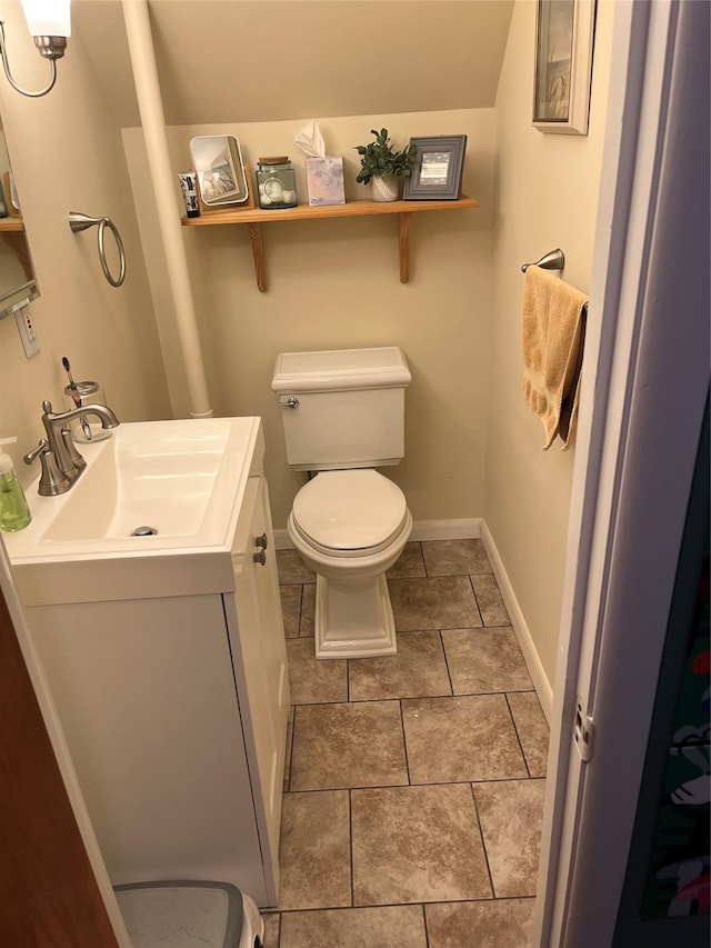 bathroom featuring vanity, tile patterned floors, toilet, and baseboards