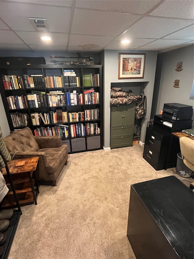 carpeted home office with visible vents and a drop ceiling