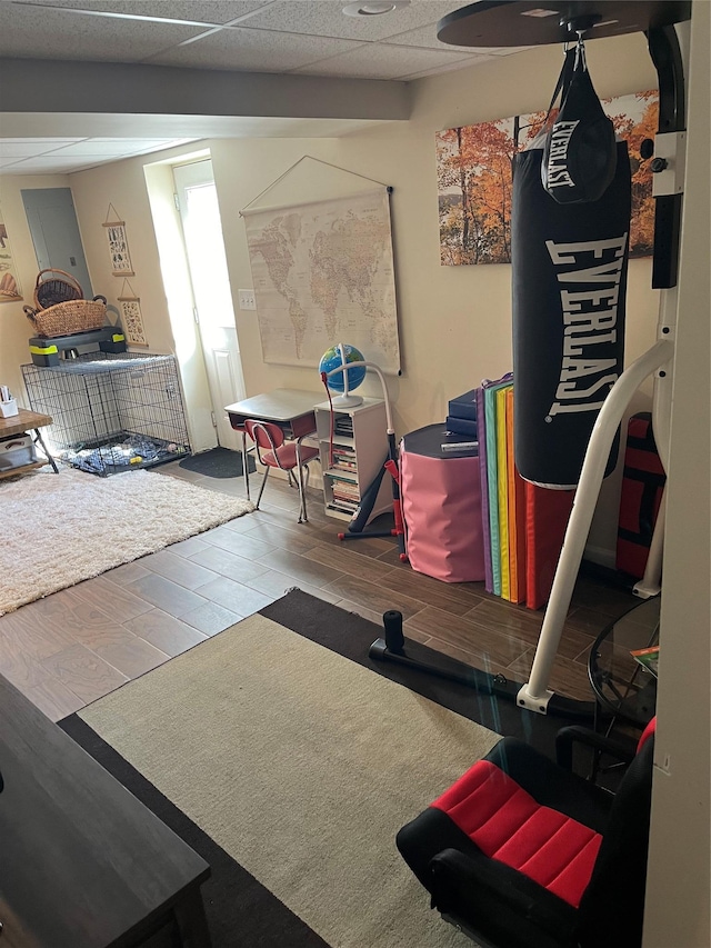 exercise area with a paneled ceiling