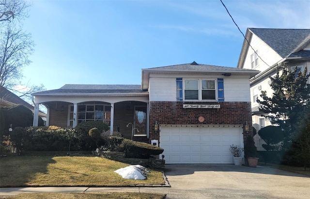 view of front facade featuring brick siding, concrete driveway, a garage, and a front yard