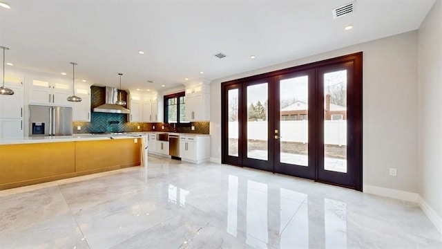 kitchen featuring visible vents, french doors, marble finish floor, stainless steel appliances, and wall chimney exhaust hood