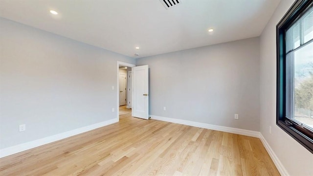 spare room with visible vents, recessed lighting, light wood-style floors, and baseboards