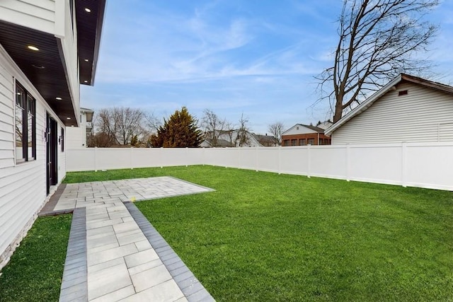 view of yard featuring a patio and a fenced backyard