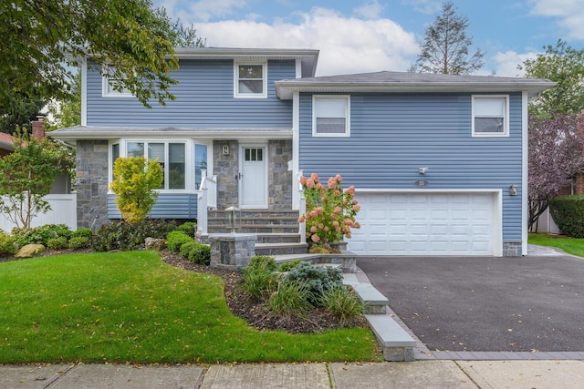 35 Roxton Rd, Plainview, NY 11803 - tri-level home featuring a front lawn, an attached garage, stone siding, and driveway
