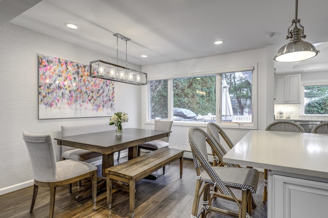 dining space with a notable chandelier, recessed lighting, baseboards, and dark wood-style flooring