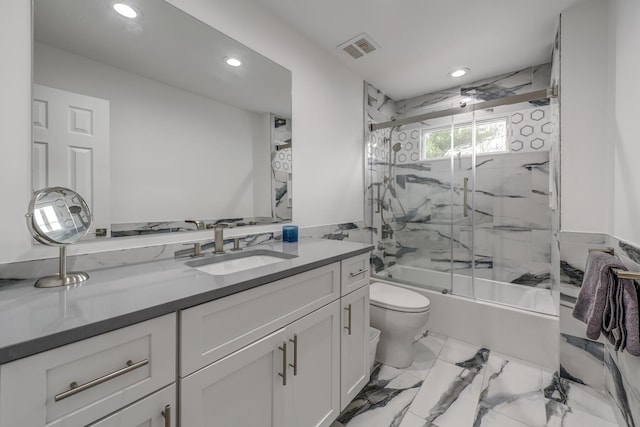 bathroom with vanity, visible vents, combined bath / shower with glass door, toilet, and marble finish floor