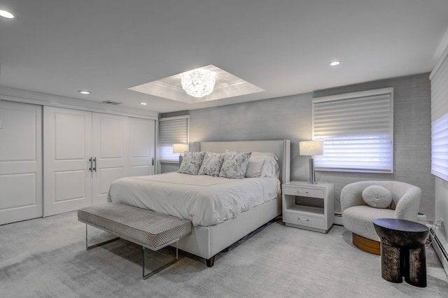 carpeted bedroom featuring a closet, recessed lighting, a baseboard heating unit, and a raised ceiling