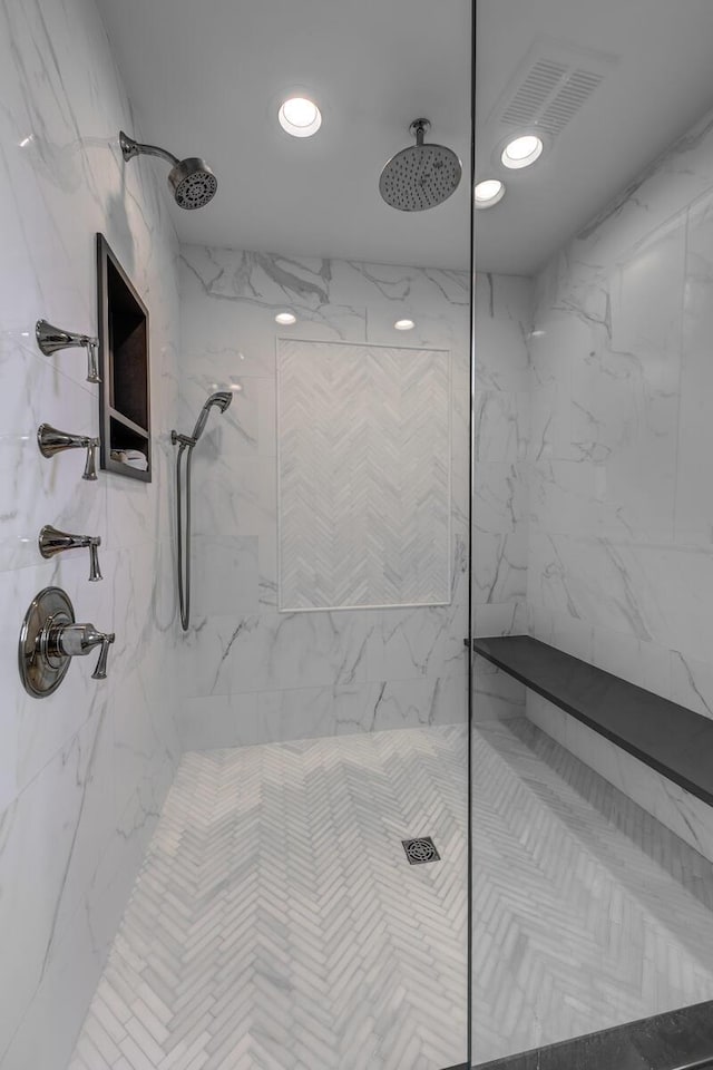 bathroom featuring recessed lighting, a marble finish shower, and visible vents