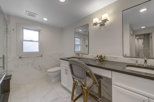 bathroom featuring plenty of natural light, visible vents, marble finish floor, and a sink