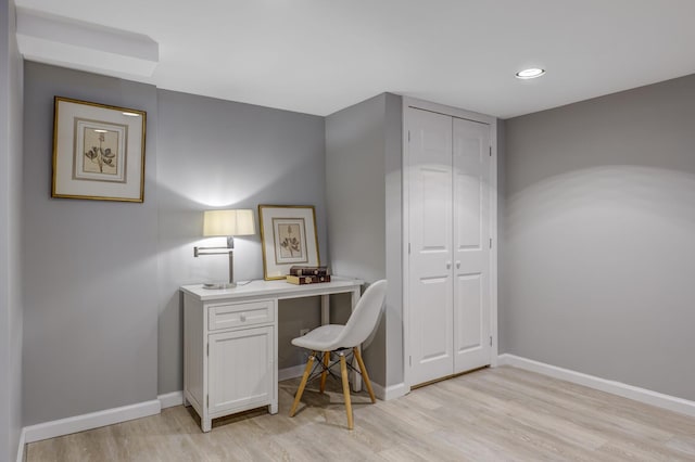 home office featuring baseboards and light wood-style floors