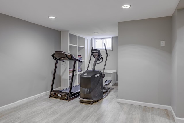 exercise area featuring recessed lighting, baseboards, and wood finished floors