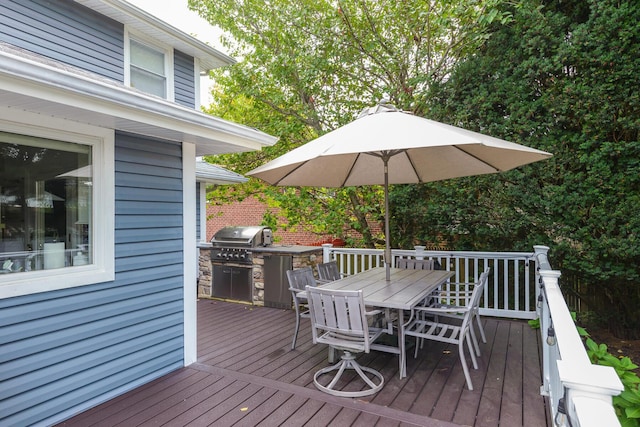 deck with area for grilling and outdoor dining space