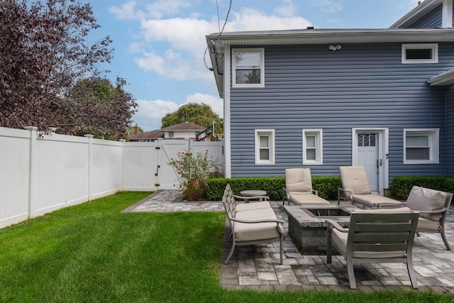 back of property with a patio, a gate, a lawn, and a fenced backyard