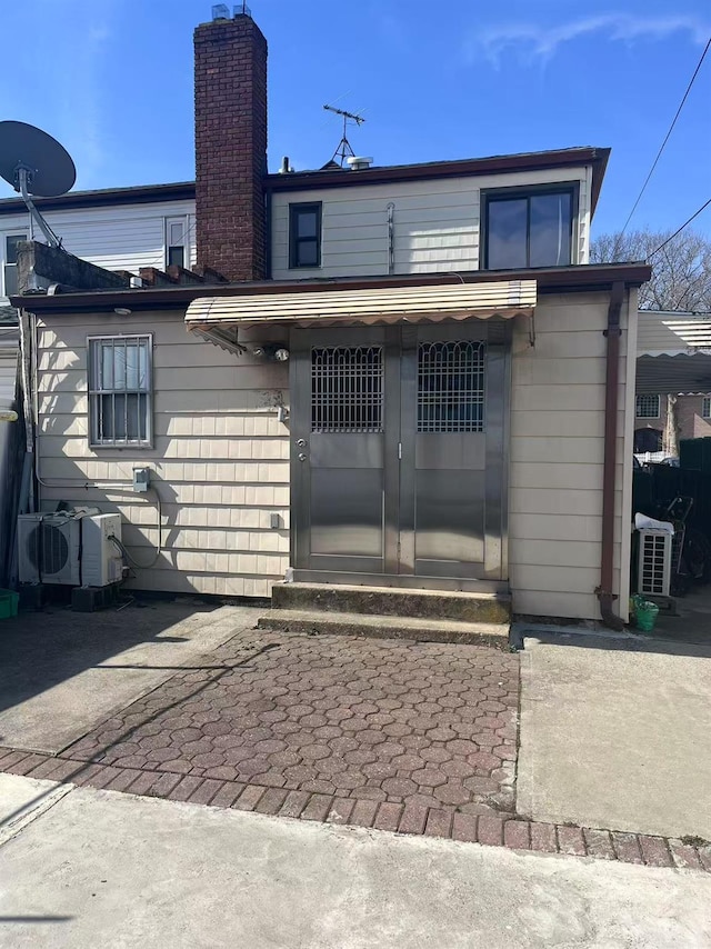 rear view of house with a chimney