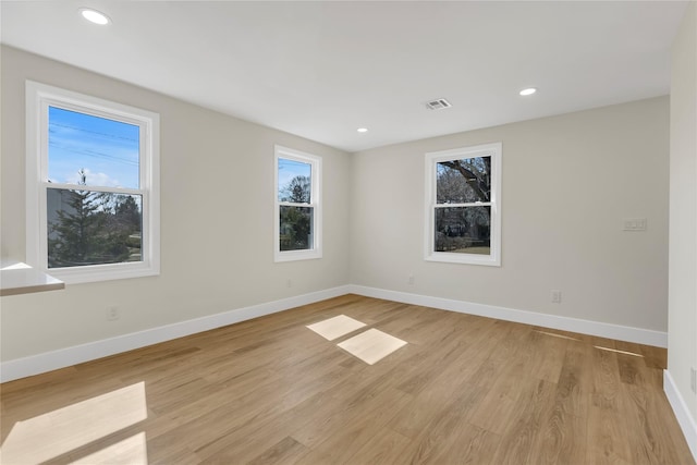 spare room featuring recessed lighting, visible vents, baseboards, and light wood-style floors