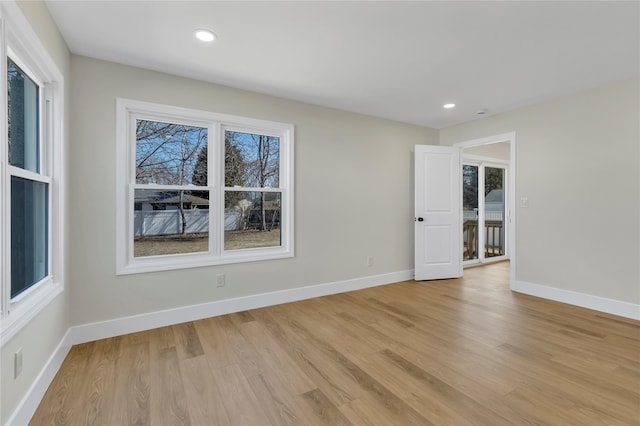 unfurnished room featuring recessed lighting, baseboards, and light wood-style floors