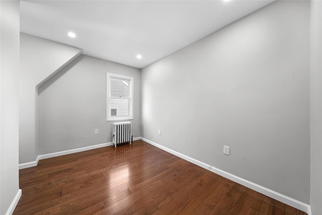 additional living space with recessed lighting, baseboards, radiator, and dark wood-style floors