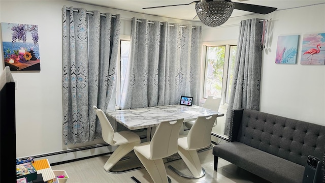 dining space featuring ceiling fan and a baseboard radiator