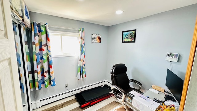 home office with a baseboard radiator and wood finished floors