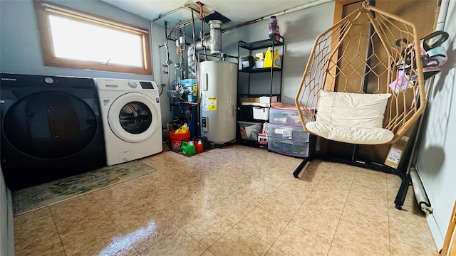 washroom featuring washer and dryer, laundry area, and water heater