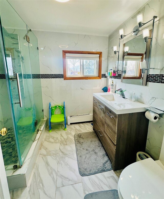 bathroom with a marble finish shower, baseboard heating, marble finish floor, and vanity