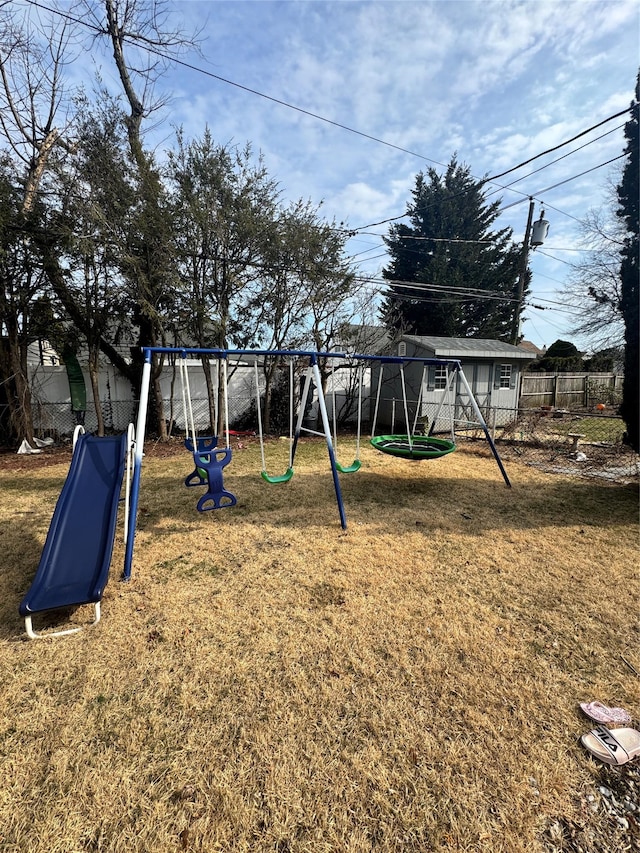 view of jungle gym featuring a yard and fence