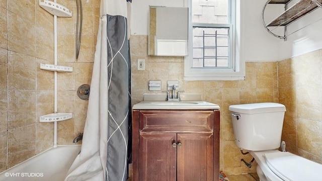 full bathroom with vanity, tile walls, and toilet