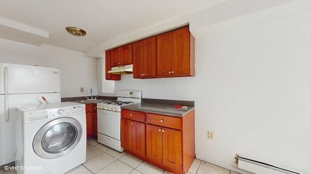 laundry area with a baseboard heating unit, light tile patterned floors, laundry area, washer / dryer, and a sink