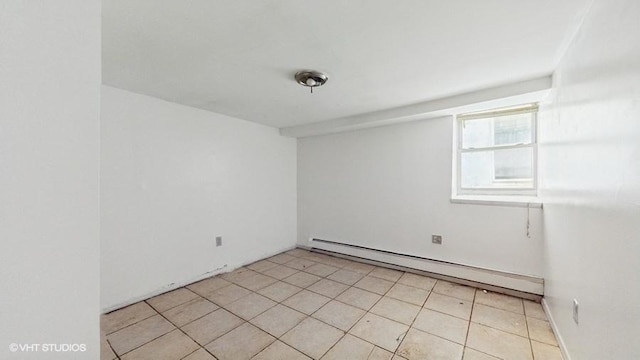 unfurnished room featuring light tile patterned flooring and a baseboard heating unit