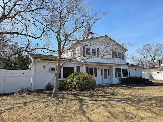 view of front of house featuring a front yard and fence