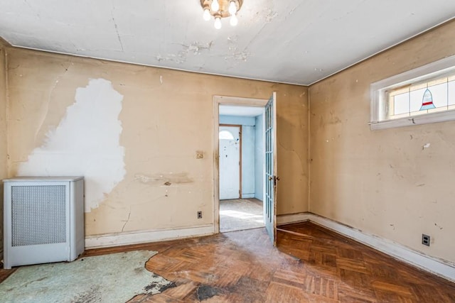 spare room featuring heating unit and baseboards