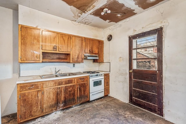 kitchen with brown cabinets, under cabinet range hood, a sink, light countertops, and white range with gas stovetop