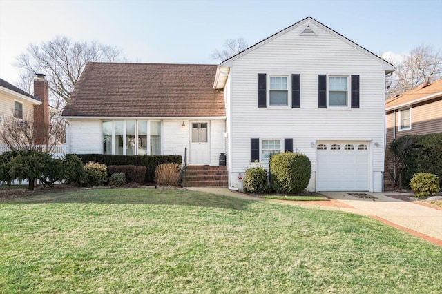 tri-level home with a front yard, concrete driveway, an attached garage, and a shingled roof