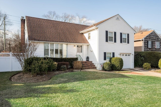 tri-level home with fence, an attached garage, a chimney, a front lawn, and concrete driveway