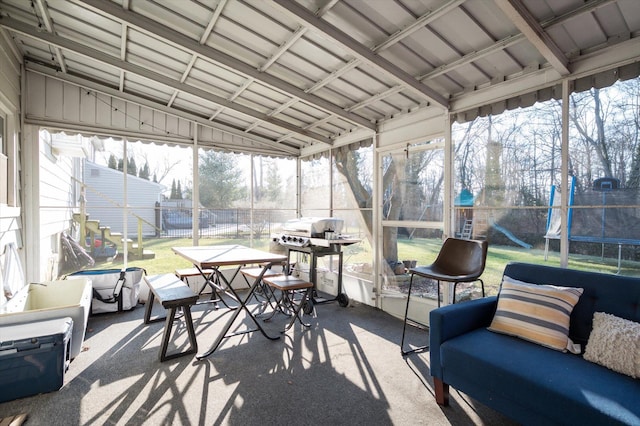 sunroom / solarium featuring plenty of natural light and vaulted ceiling