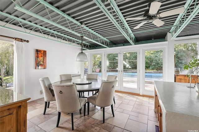 sunroom / solarium with french doors, a wealth of natural light, and ceiling fan