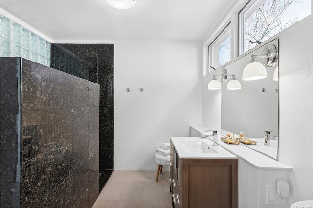 bathroom featuring vanity, a walk in shower, and tile patterned flooring