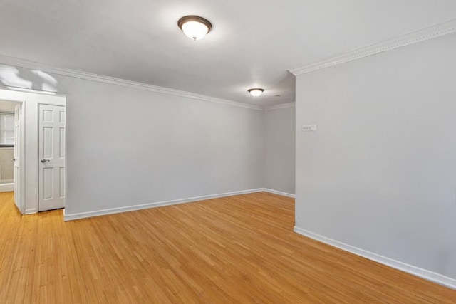 unfurnished room featuring baseboards, crown molding, and light wood-style floors