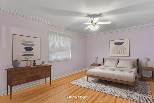 bedroom featuring light wood-style flooring, a ceiling fan, baseboards, and ornamental molding