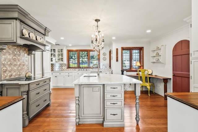 kitchen featuring ornamental molding, gray cabinetry, black electric cooktop, and a sink